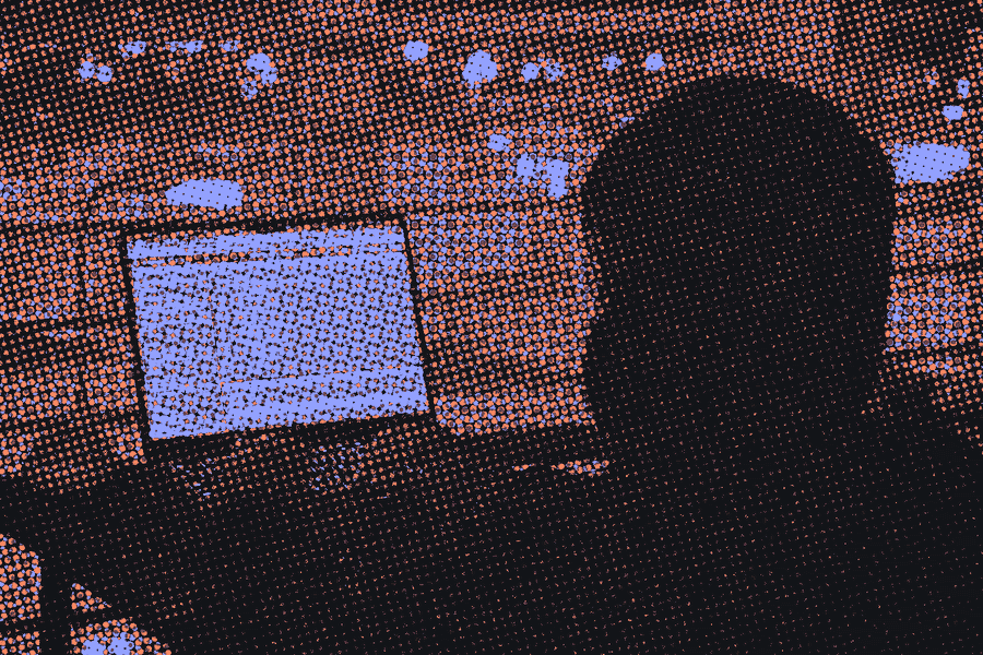 A silhouette coding on a laptop at night