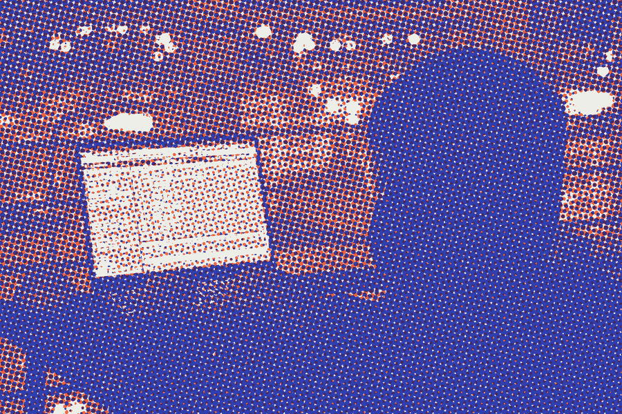 A silhouette coding on a laptop at night