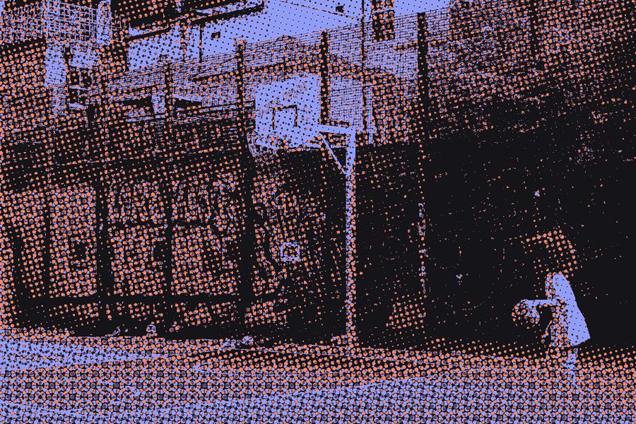 A kid dribbling on a fenced city court