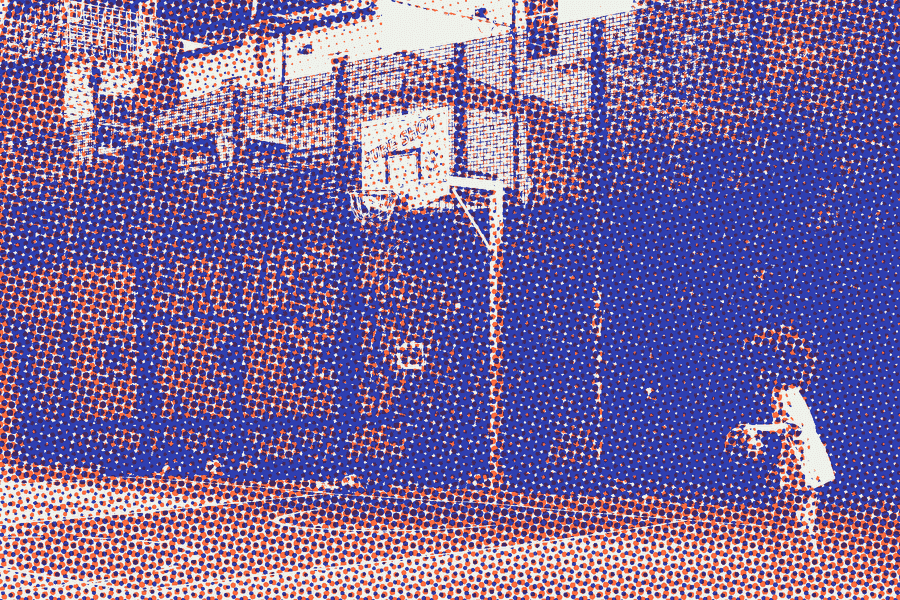 A kid dribbling on a fenced city court